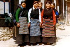 China - Tibet - Lhasa - Ladies in Sera monastery. These women came and brushed their hair and aprons and wanted us to take their pictures. So we did. Unfortunately it turned out that they thought we had Polaroid cameras with instant processing and printing. The disappointment was big when they discovered the truth. They had apparently met or heard of charter tourists with such cameras. No “travellers” have them.