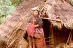 Thailand - Golden Triangle Trekking - Young hill tribe woman outside her cabin in Northern Thailand