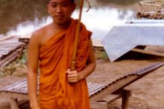 Thailand - Mae Sai - Young Buddhist monk with umbrella